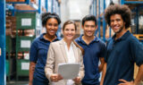 Warehouse manager with workers in factory