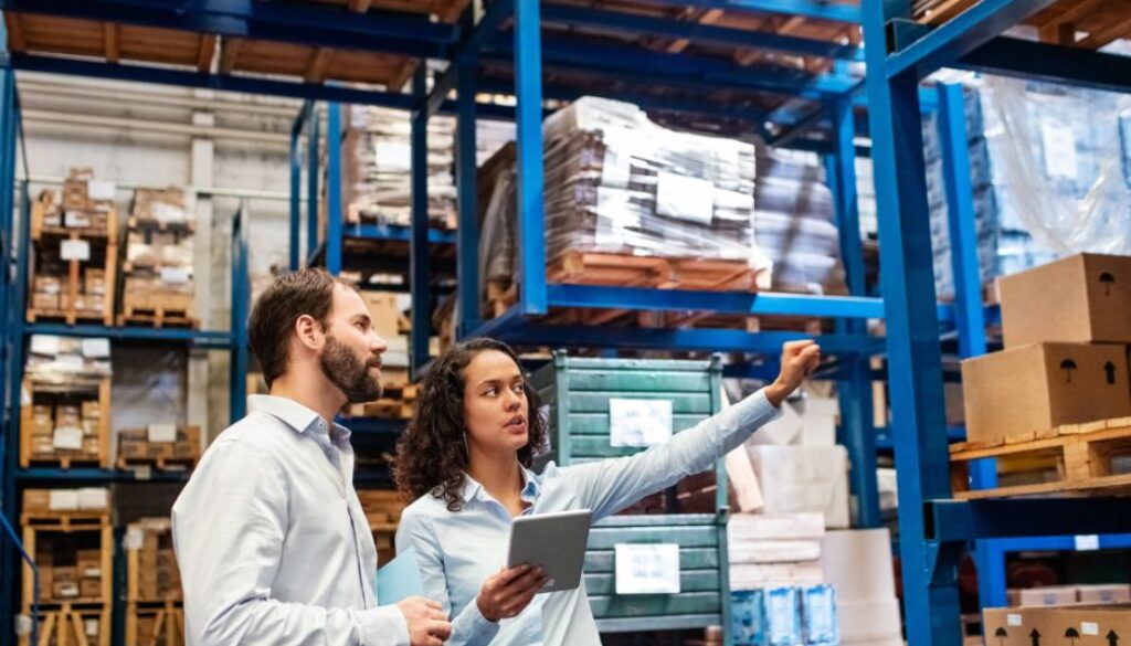 Warehouse supervisor with clipboard training a new hire in a Richmond VA facility