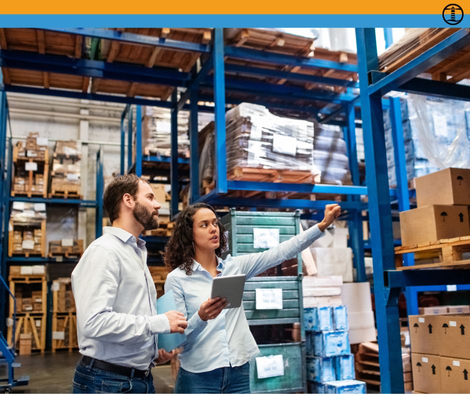 Warehouse supervisor with clipboard training a new hire in a Richmond VA facility