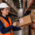 warehouse worker scanning inventory box in distribution center during career transition from retail