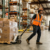 Material handler operating a pallet jack in a Virginia warehouse distribution center