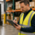 Warehouse supervisor reviewing hiring information while recruiting warehouse employees.