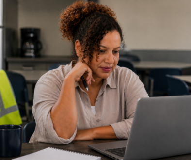 Job seeker reviewing a warehouse job posting on a laptop