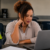 Job seeker reviewing a warehouse job posting on a laptop