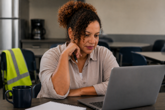 Job seeker reviewing a warehouse job posting on a laptop