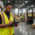 Warehouse supervisor reviewing workforce data on the floor of a Virginia distribution center